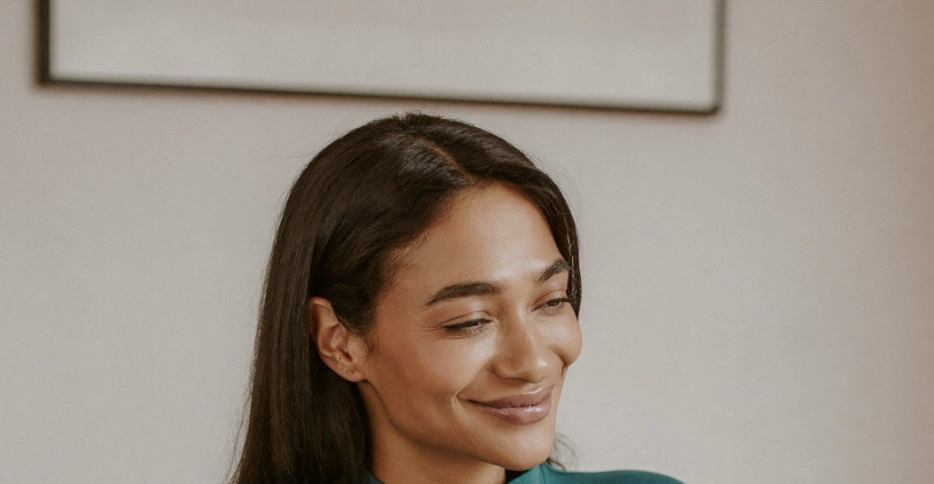 A woman calmly considering her options with quiet confidence