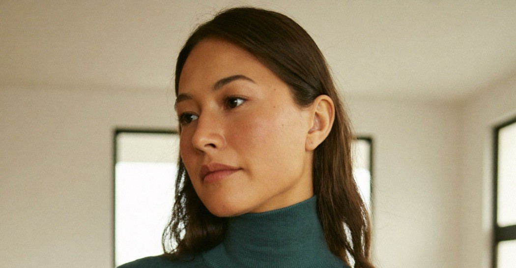 A confident woman calmly considering her decision, at ease in a bright modern home