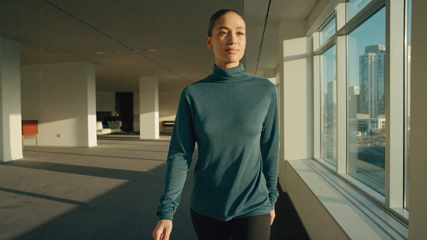 A self-assured woman walking through a bright modern space