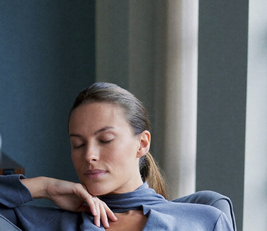A calm woman resting comfortably at home during a light recovery